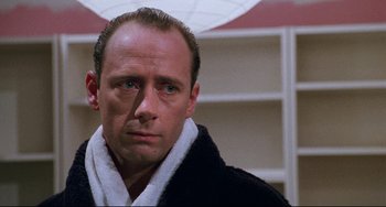 Movie still from “Candyman” (1992), directed by Bernard Rose – A person wearing a bathrobe; Close Up shot, Low angle