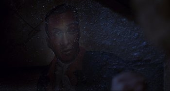 Movie still from “Candyman” (1992), directed by Bernard Rose – A picture of a man's face through a window; Extreme Close Up shot, Overhead angle