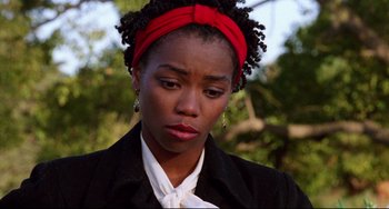 Movie still from “Candyman” (1992), directed by Bernard Rose – A woman with a red head band is looking sad; Close Up shot, Over the shoulder angle