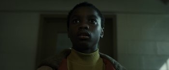 Movie still from “Candyman” (2021), directed by Nia DaCosta – A young black boy looking up at the ceiling; Close Up shot, Low angle