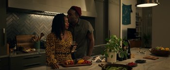 Movie still from “Candyman” (2021), directed by Nia DaCosta – A man and a woman kissing in a kitchen; Medium shot, Over the shoulder angle