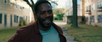 Movie still from “Candyman” (2021), directed by Nia DaCosta – A person wearing a jacket; Close Up shot, Over the shoulder angle