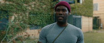 Movie still from “Candyman” (2021), directed by Nia DaCosta – A person wearing a hat; Close Up shot, Over the shoulder angle