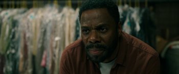 Movie still from “Candyman” (2021), directed by Nia DaCosta – A person wearing a shirt; Close Up shot, Over the shoulder angle