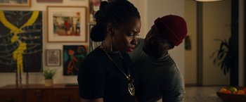 Movie still from “Candyman” (2021), directed by Nia DaCosta – A man and a woman standing next to each other; Medium shot, Over the shoulder angle