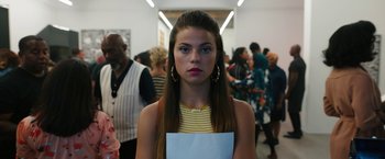 Movie still from “Candyman” (2021), directed by Nia DaCosta – A woman standing in front of a group of people; Close Up shot, Low angle
