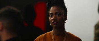 Movie still from “Candyman” (2021), directed by Nia DaCosta – A person wearing a yellow shirt; Close Up shot, Over the shoulder angle