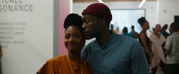 Movie still from “Candyman” (2021), directed by Nia DaCosta – A man and a woman are posing for a picture; Close Up shot, Over the shoulder angle