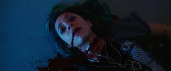 Movie still from “Candyman” (2021), directed by Nia DaCosta – A woman with blood all over her face and neck; Close Up shot, Overhead angle