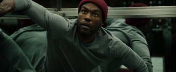 Movie still from “Candyman” (2021), directed by Nia DaCosta – A person wearing a hat; Close Up shot, Overhead angle