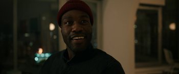 Movie still from “Candyman” (2021), directed by Nia DaCosta – A person wearing a hat; Close Up shot, Over the shoulder angle