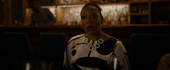 Movie still from “Candyman” (2021), directed by Nia DaCosta – A black and white woman wearing a necklace; Close Up shot, Over the shoulder angle