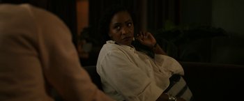 Movie still from “Candyman” (2021), directed by Nia DaCosta – A woman sitting in front of a mirror in a room; Close Up shot, Over the shoulder angle