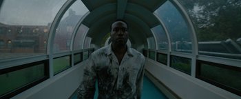 Movie still from “Candyman” (2021), directed by Nia DaCosta – A man standing in a tunnel looking at the camera; Medium shot, Low angle