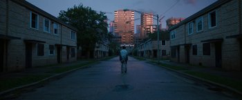 Movie still from “Candyman” (2021), directed by Nia DaCosta – A man standing in the middle of an empty street at night; Extreme Wide shot, Low angle