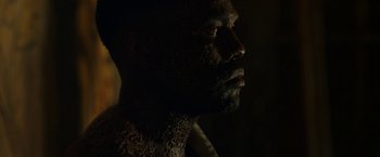 Movie still from “Candyman” (2021), directed by Nia DaCosta – A person's face in the dark; Close Up shot, Low angle