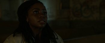 Movie still from “Candyman” (2021), directed by Nia DaCosta – A person looking up at the ceiling; Close Up shot, Over the shoulder angle