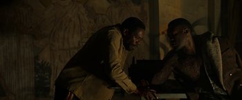 Movie still from “Candyman” (2021), directed by Nia DaCosta – A man and a woman standing next to each other; Medium shot, Over the shoulder angle