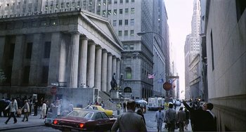 Movie still from “Cannibal Holocaust” (1980), directed by Ruggero Deodato – A city street with a lot of people walking on the sidewalk; Extreme Wide shot, Low angle