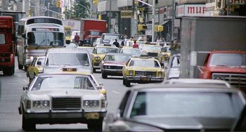Movie still from “Cannibal Holocaust” (1980), directed by Ruggero Deodato – A bunch of cars that are in the street; Extreme Wide shot, High angle