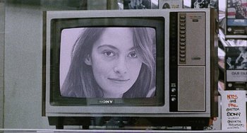 Movie still from “Cannibal Holocaust” (1980), directed by Ruggero Deodato – A black and white photo of a woman's face on a television screen; Extreme Close Up shot, Over the shoulder angle