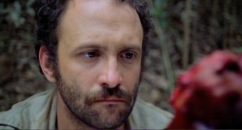 Movie still from “Cannibal Holocaust” (1980), directed by Ruggero Deodato – A person with a beard; Close Up shot, Low angle
