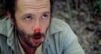Movie still from “Cannibal Holocaust” (1980), directed by Ruggero Deodato – A person with a nose bleed; Extreme Close Up shot, Low angle