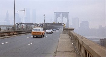 Movie still from “Cannibal Holocaust” (1980), directed by Ruggero Deodato – Cars are driving on a bridge over a river; Extreme Wide shot, High angle