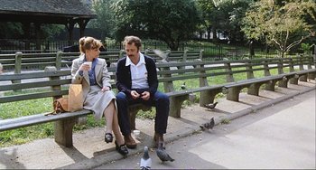 Movie still from “Cannibal Holocaust” (1980), directed by Ruggero Deodato – A man and a woman sitting on a park bench; Wide shot, High angle