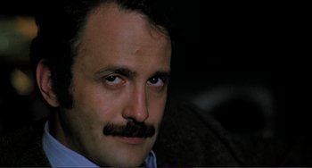 Movie still from “Cannibal Holocaust” (1980), directed by Ruggero Deodato – A person with a mustache; Close Up shot, Low angle