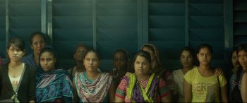 Movie still from “Capernaum” (2018), directed by Nadine Labaki – A group of women sitting next to each other in a room; Medium shot, Low angle