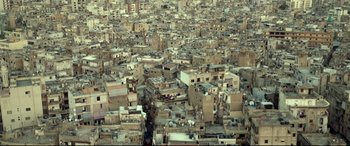 Movie still from “Capernaum” (2018), directed by Nadine Labaki – An aerial view of a large city with many buildings; Extreme Wide shot, Overhead angle