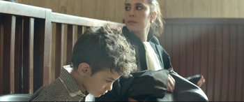 Movie still from “Capernaum” (2018), directed by Nadine Labaki – A woman and a boy sitting next to each other on a bench; Close Up shot, Over the shoulder angle
