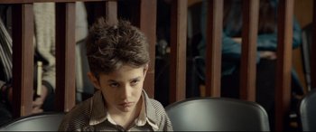 Movie still from “Capernaum” (2018), directed by Nadine Labaki – A young boy is sitting in front of a mirror; Close Up shot, Over the shoulder angle