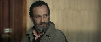 A man with a beard and a jacket on