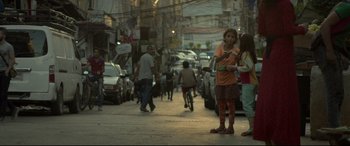 Movie still from “Capernaum” (2018), directed by Nadine Labaki – A group of people walking down a street; Extreme Wide shot, Over the shoulder angle