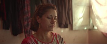 Movie still from “Capernaum” (2018), directed by Nadine Labaki – A person with her eyes closed; Close Up shot, Over the shoulder angle