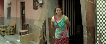 Movie still from “Capernaum” (2018), directed by Nadine Labaki – A woman standing next to a wall in a room; Medium shot, Over the shoulder angle