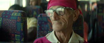 Movie still from “Capernaum” (2018), directed by Nadine Labaki – An old man wearing glasses and a pink turban; Close Up shot, Over the shoulder angle