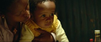 Movie still from “Capernaum” (2018), directed by Nadine Labaki – A child wearing a yellow scarf; Close Up shot, Over the shoulder angle