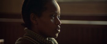 Movie still from “Capernaum” (2018), directed by Nadine Labaki – A person looking at the camera; Close Up shot, Over the shoulder angle
