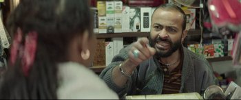 A man is talking to a woman in a store