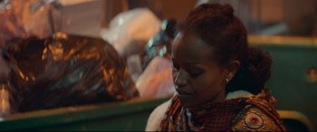Movie still from “Capernaum” (2018), directed by Nadine Labaki – A person sitting down looking down; Close Up shot, Over the shoulder angle