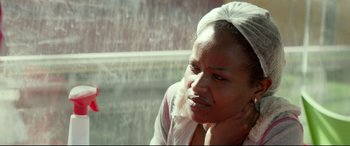 Movie still from “Capernaum” (2018), directed by Nadine Labaki – A person sitting in front of a window; Close Up shot, Over the shoulder angle