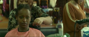 Movie still from “Capernaum” (2018), directed by Nadine Labaki – A person getting their hair cut at a barber shop; Close Up shot, Over the shoulder angle