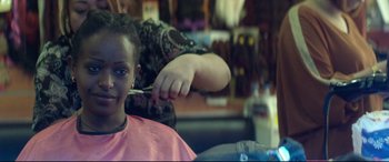 Movie still from “Capernaum” (2018), directed by Nadine Labaki – A person cutting a child's hair in a barber shop; Close Up shot, Over the shoulder angle