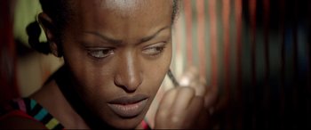 Movie still from “Capernaum” (2018), directed by Nadine Labaki – A woman's face looking down; Close Up shot, Over the shoulder angle