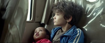 Movie still from “Capernaum” (2018), directed by Nadine Labaki – A young boy and a young girl sitting in a car; Close Up shot, Low angle