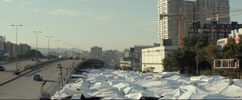 Movie still from “Capernaum” (2018), directed by Nadine Labaki – A view of a city from across the river; Extreme Wide shot, High angle