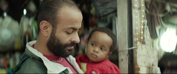 Movie still from “Capernaum” (2018), directed by Nadine Labaki – A man and a child are looking at each other; Close Up shot, Over the shoulder angle